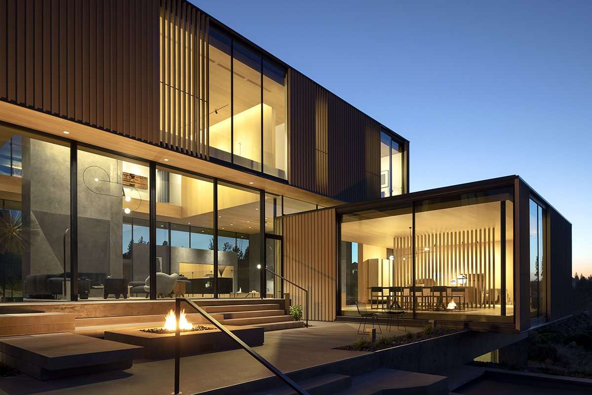 Exterior view of wood clad modern home with fire pit