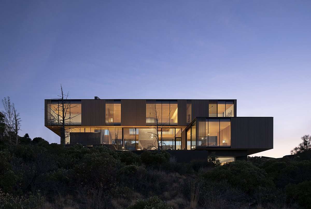 Image of modern home with lights on at night