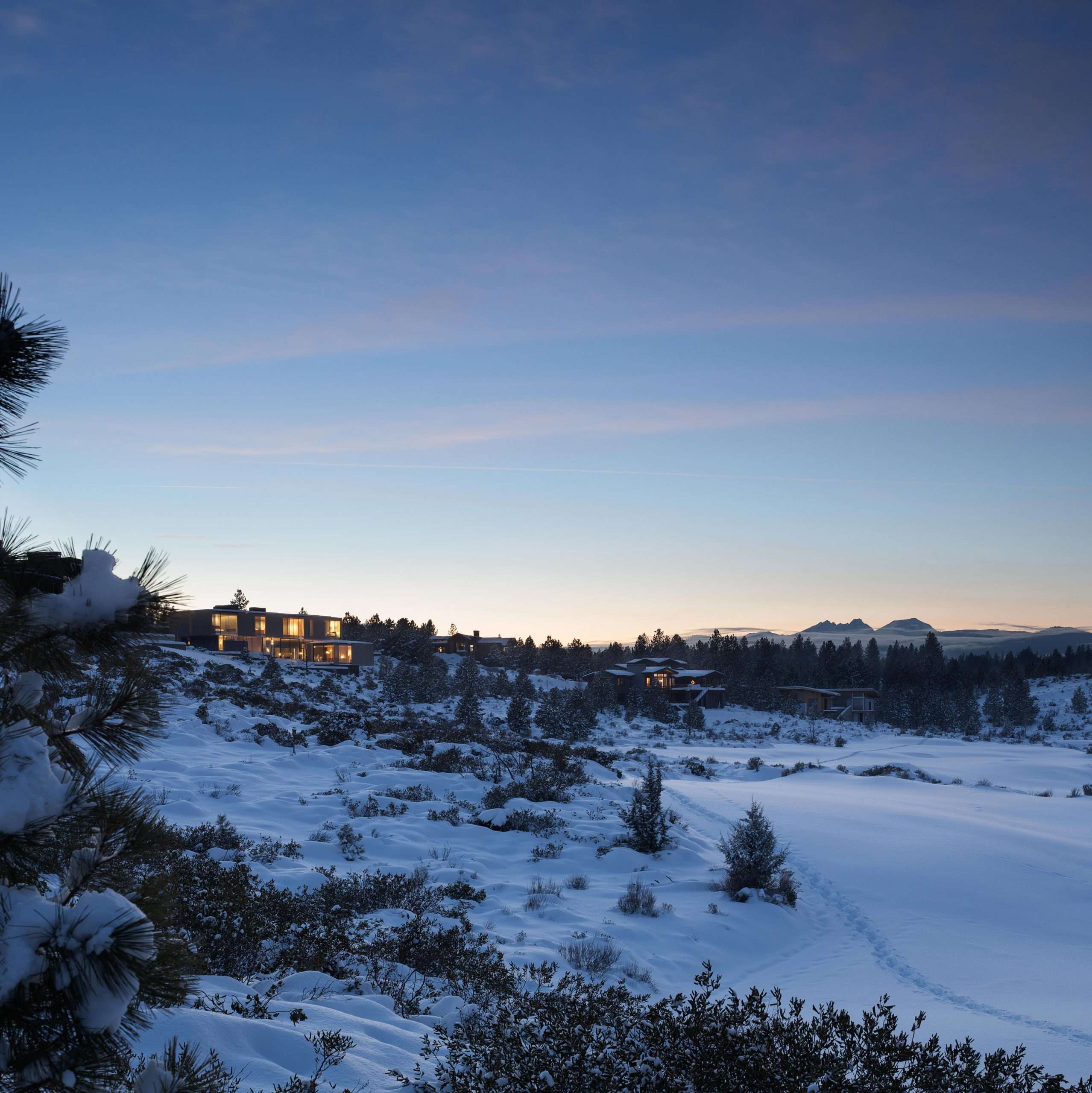 Custom home in snow landcape at dusk