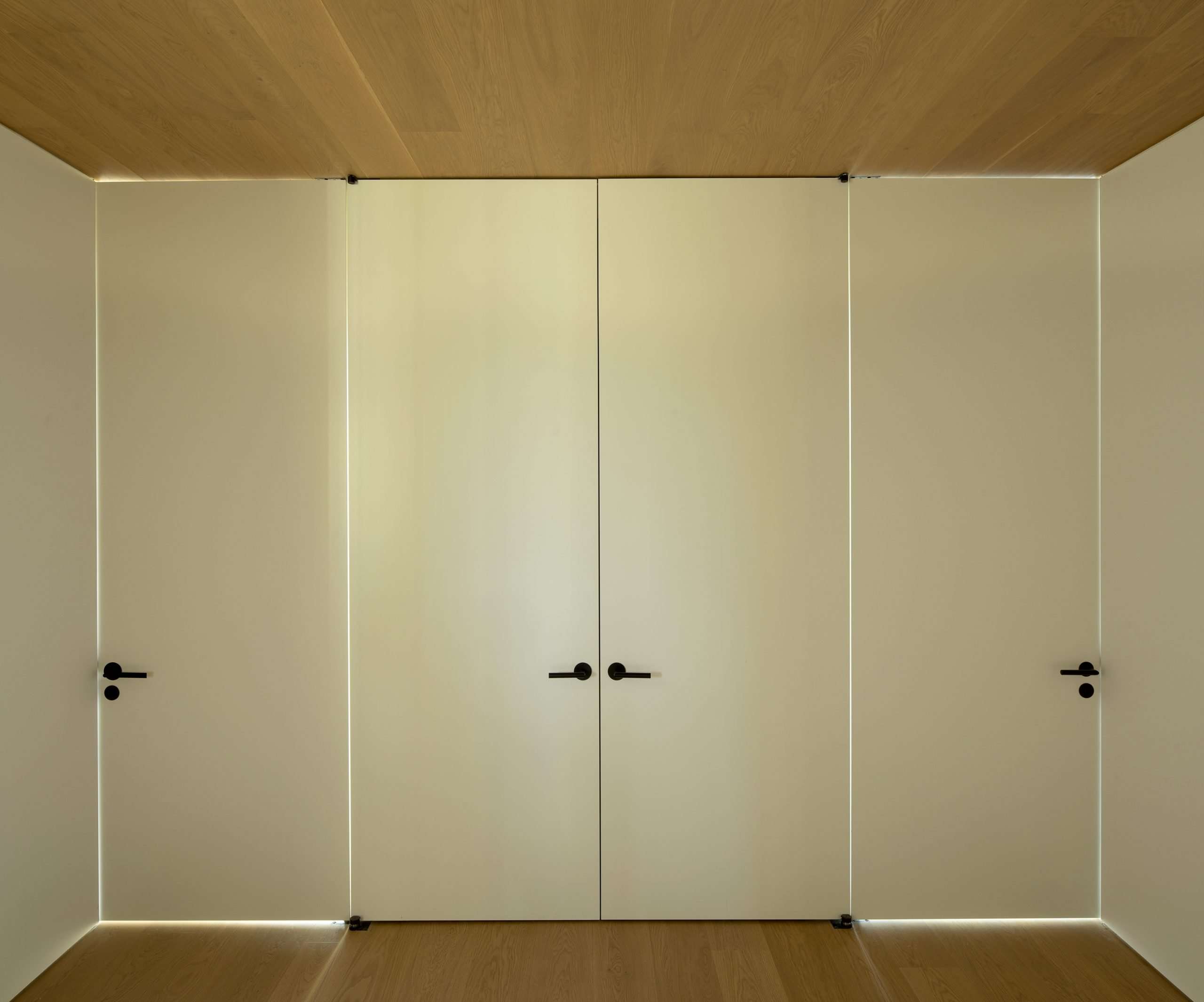 Closed doors to side by side guest rooms