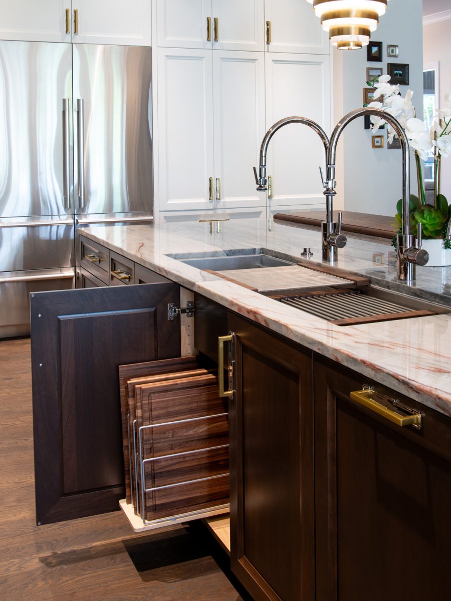 Modern kitchen with marble countertop, stainless steel sink, and dark wooden cabinets.