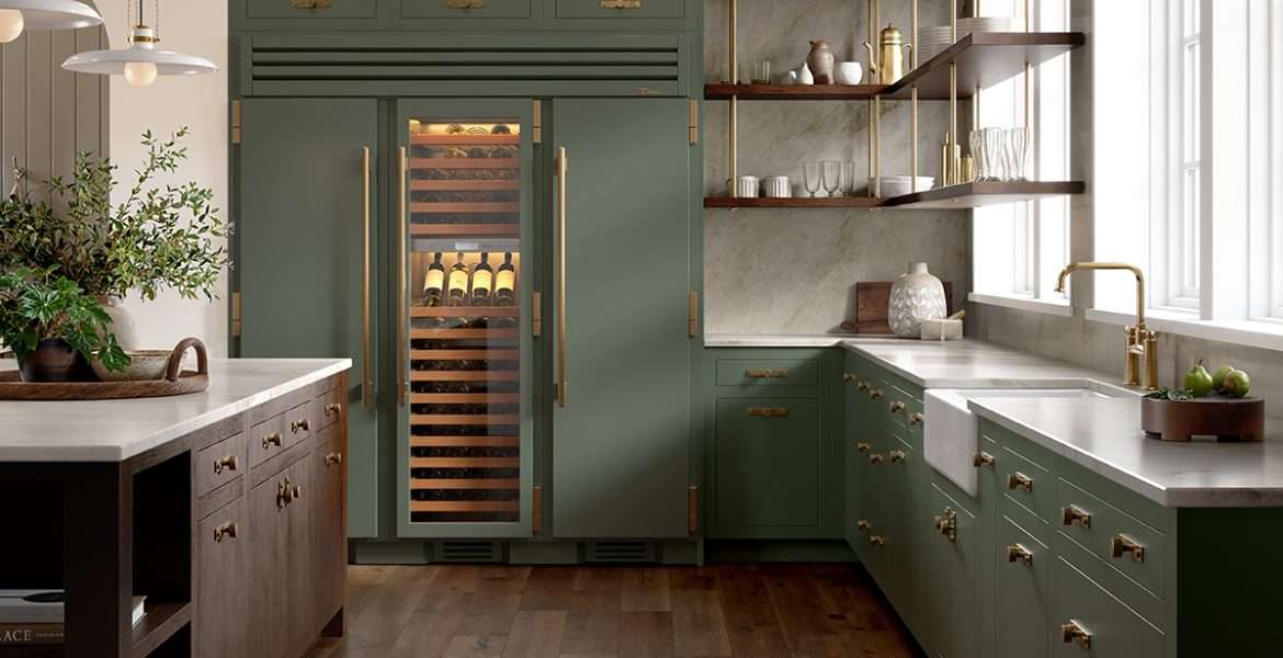 Kitchen with island and green cabinetry and column wine refrigeration