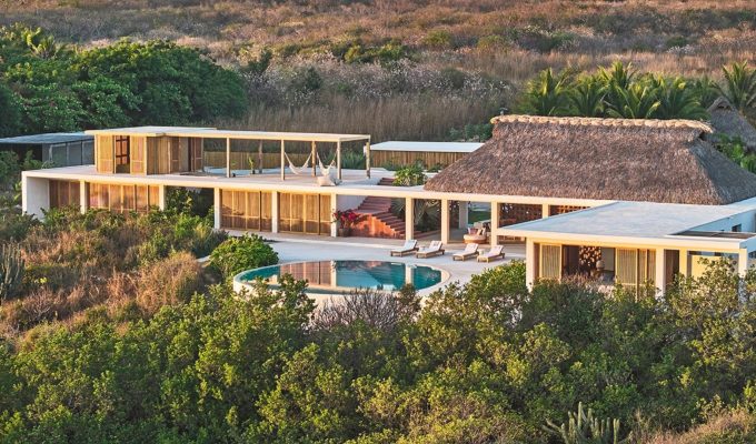 Aerial view of Casa Maya, a palapa-roofed house with a pool by Meyer Davis on the coast of Oaxaca, Mexico