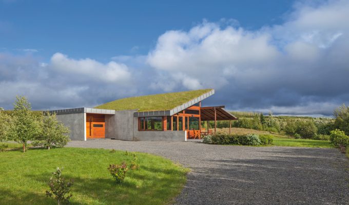 Big Little Rock, a modern Icelandic turf house by Minarc with a sloped living sod roof