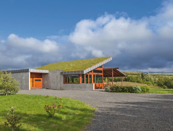 Big Little Rock, a modern Icelandic turf house by Minarc with a sloped living sod roof